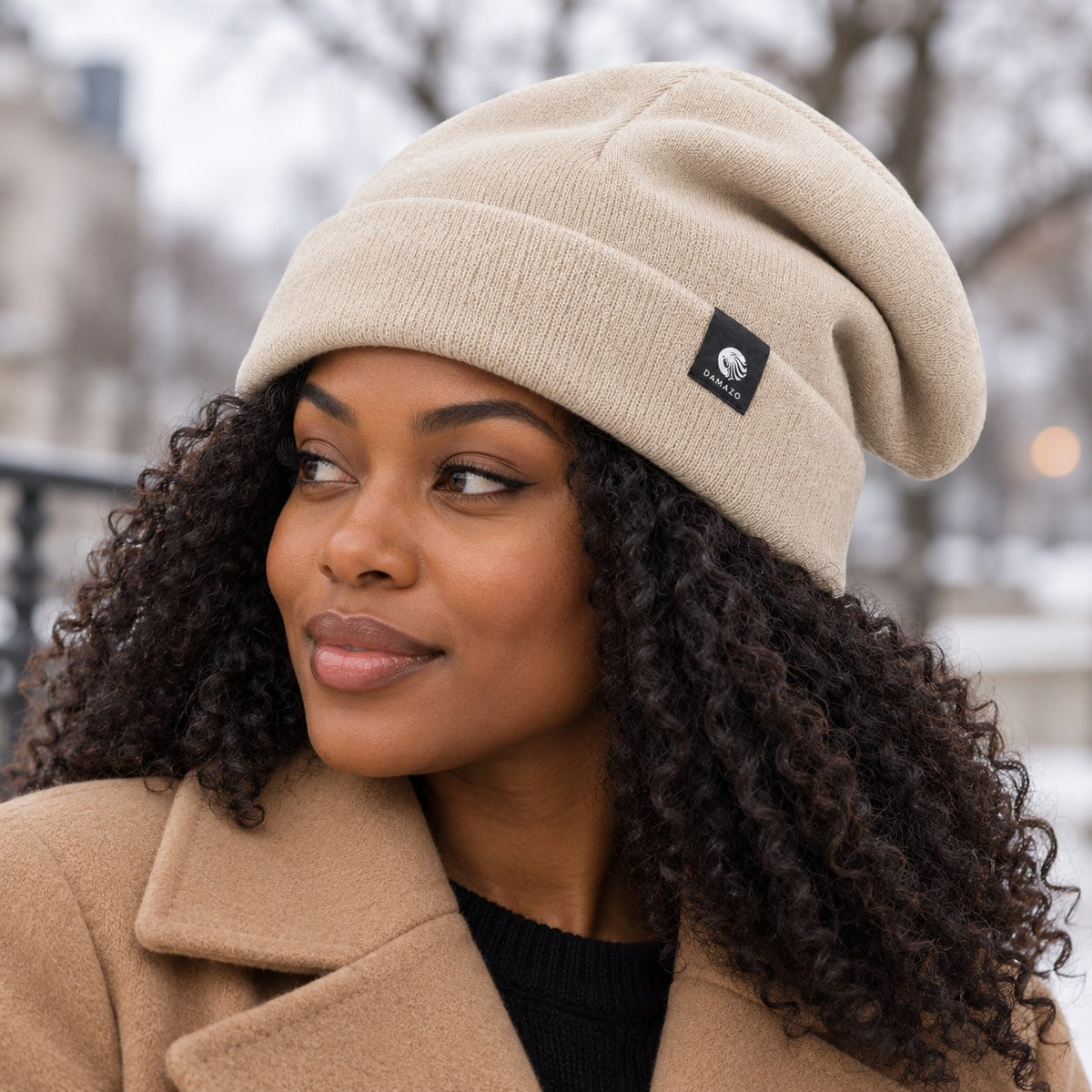 Cream NYX Oversized silk-lined wool beanie, worn over curly hair