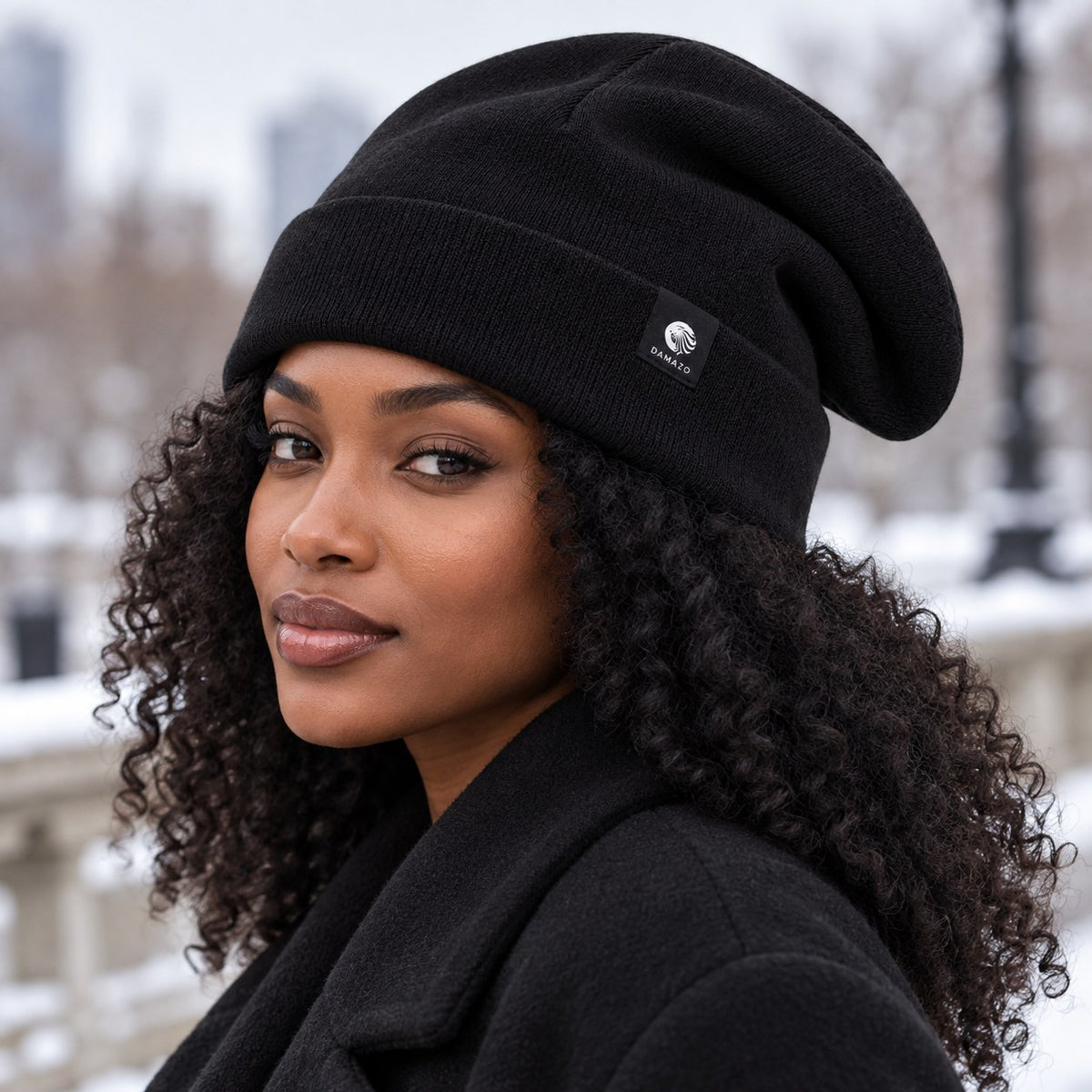 Black oversized silk-lined wool beanie, worn over curly hair