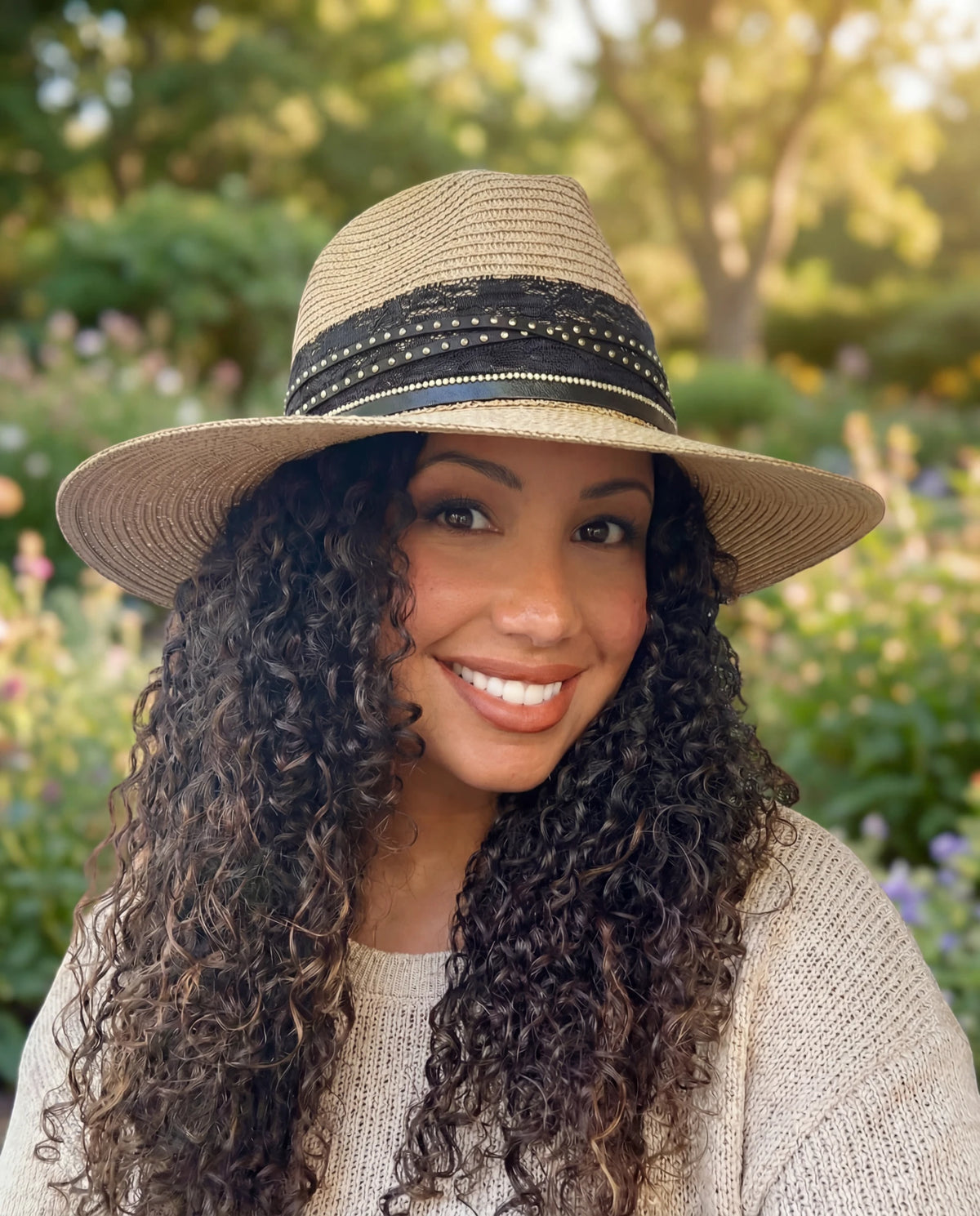 Woman with curly hair wearing a wide-brim straw hat